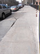 THIS BUSTED AND CRATERED SIDEWALK IS IN FRONT OF 131 JERSEY STREET!! IS HAS BEEN BROKEN FOR MANY, MANY YEARS!!