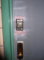 Here The New York City Housing Authority Has Installed A Plate Over The Lock Cylinder With Only Three External Screws Holding It On!!  Any One With A Phillips Screwdriver Can Remove It!!